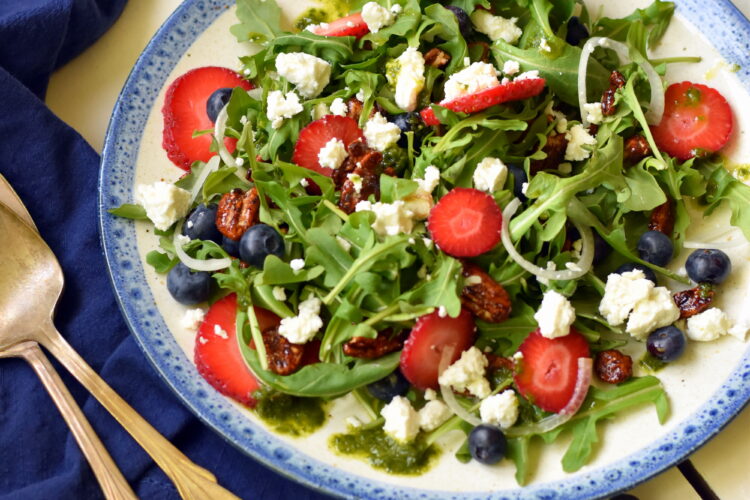 Plate of berry salad, napkin and utensils