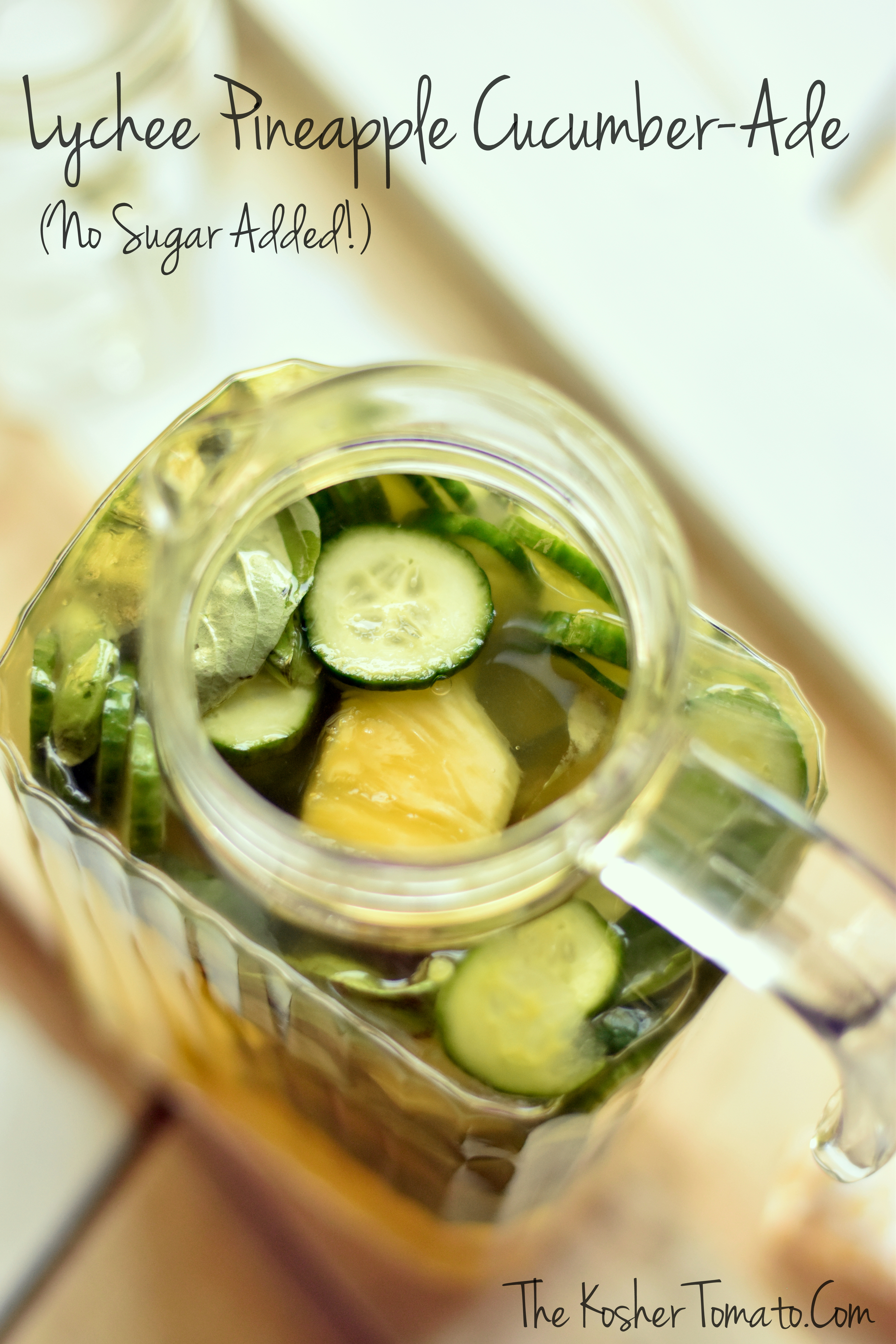 pitcher closeup with cucumbers, basil and pineapple